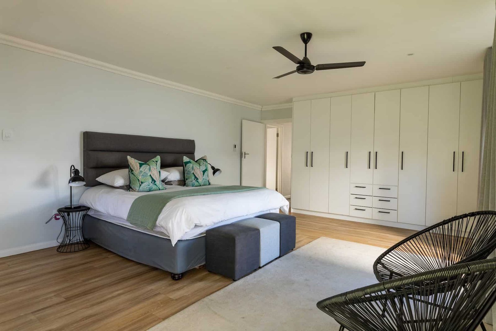 Services 11 interior-of-bedroom-with-bed-and-wardrobe-by-chairs-at-home